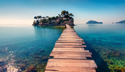 a wooden dock leading to an island