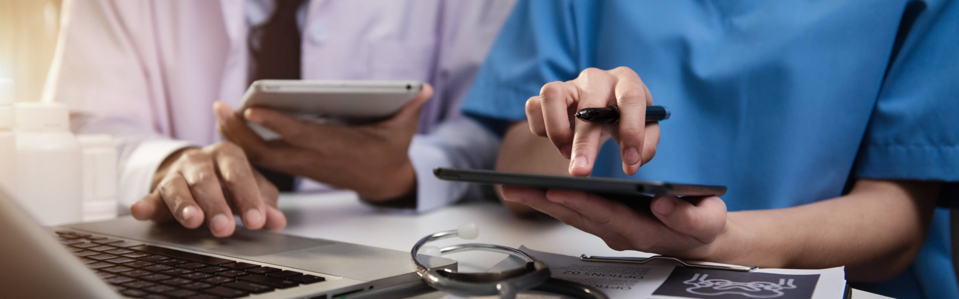 Doctors working together on digital tablet