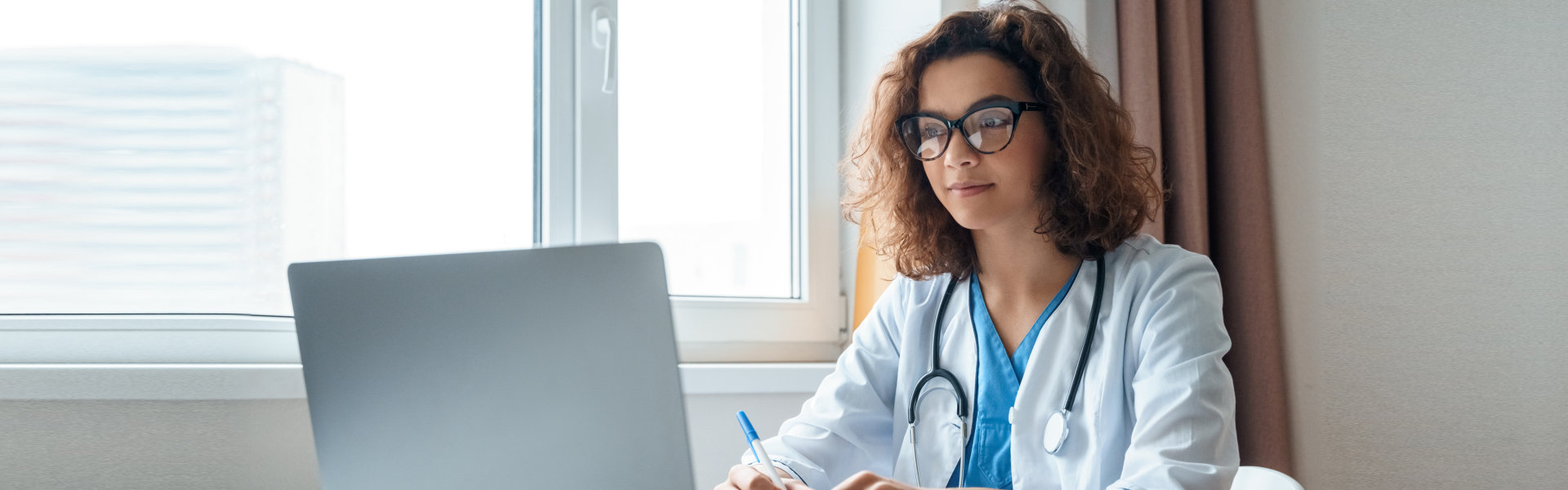 young doctor in front of a computer